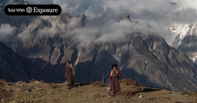 Two women walking the highlands of Lunana, Bhutan, below the mountains