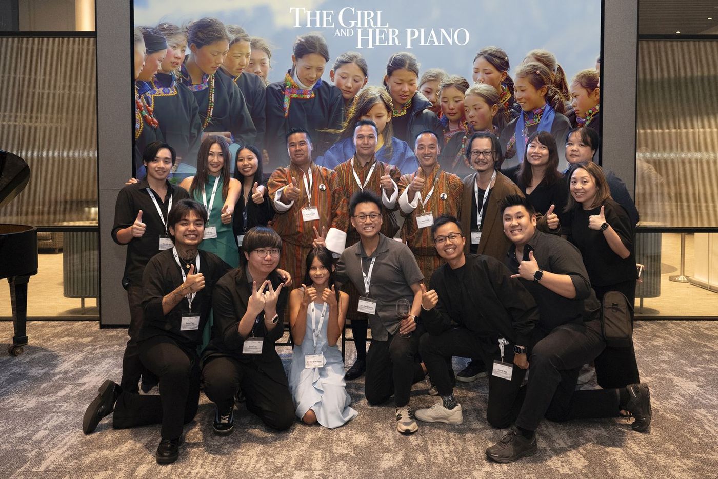 The team photographed together in front of the poster at the Singapore premiere